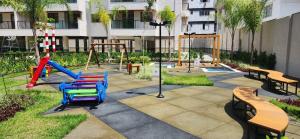 a playground with colorful chairs and benches in a park at Ocean garden in Cabo Frio