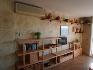 a living room with a book shelf and a tv at Medas Park 261 - L'Estartit, Centro - ES-323-89 in Torroella de Montgrí +26 photos