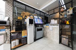 a store with a refrigerator and a tv in it at MyeongDong New Stay Inn in Seoul