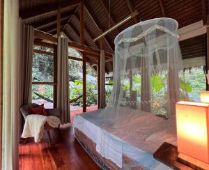 a bedroom with a bed with a canopy at Dalakit House Villa Two in Siquijor