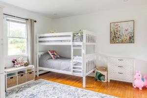 a white bedroom with a white bunk bed at The Yuzu stunning mountain retreat with hot tub in Gardiner