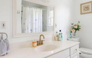 a white bathroom with a sink and a toilet at The Yuzu stunning mountain retreat with hot tub in Gardiner +73 photos