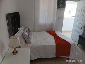 En eller flere senger på et rom på Aparta Hotel Jiménez