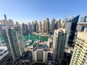 a view of a city with tall buildings and a harbor at 2 Bed Apartment in La Riviera Tower, Dubai Marina near Metro and Mall, 12-min walk to JBR Beach! in Dubai