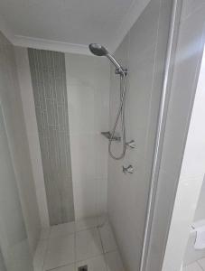 a shower with a shower head in a bathroom at Oceanfront 24th Floor 1 Bedroom Retreat with Stunning Views & Free Parking in Gold Coast +21 photos