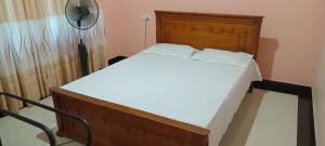 Postel nebo postele na pokoji v ubytování Suduganga inn