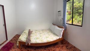 Postel nebo postele na pokoji v ubytování Baron Tourist Inn + 3 fotografie