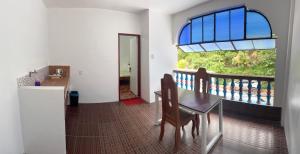 a dining room with a table and a window at Baron Tourist Inn in El Nido