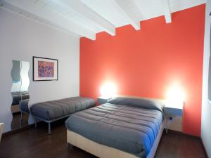 a room with two beds and a red wall at B&B Il Falco in Castel del Monte +74 photos