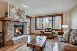 a living room with a couch and a fireplace at Cozy Ski Chalet with Large Balcony condo in Breckenridge