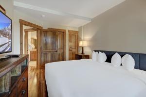 a bedroom with a large bed and a television at Cozy Ski Chalet with Large Balcony condo in Breckenridge