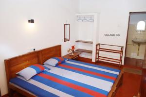 Postel nebo postele na pokoji v ubytování Village Inn