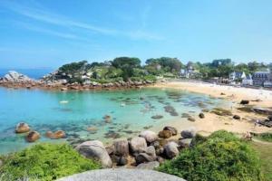 a beach with a bunch of rocks in the water at The Cuban & SPA Privé in Perros-Guirec +11 photos