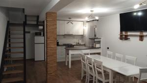 a kitchen and dining room with a table and chairs at Casa Noastră in Vidra