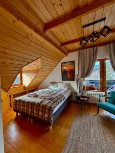 a bedroom with a large bed and a wooden ceiling at Michałówka na Kubalowej Łące in Szczyrk