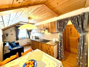 a kitchen with a table and a dining room at Ciasa Rü in San Cassiano
