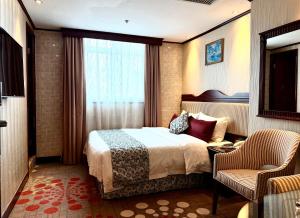 Voodi või voodid majutusasutuse Macau Masters Hotel toas