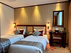 Voodi või voodid majutusasutuse Macau Masters Hotel toas