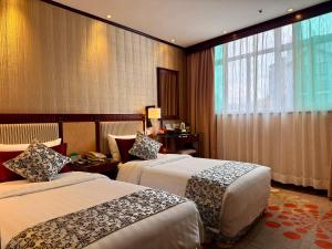 Voodi või voodid majutusasutuse Macau Masters Hotel toas