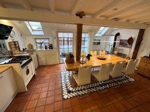 a kitchen with a wooden table and chairs and a dining room at Ferienwohnung im Erdgeschoss "Huus an`t Koornfeld" in Osteel