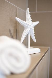a white starfish sitting on top of a counter at Surfside Penthouse in Bournemouth