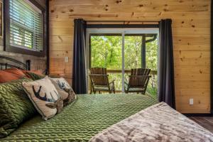 a bedroom with a bed and a large window at Mountain Majesty By Ghosal Luxury Lodging in Gatlinburg +64 photos