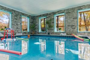 a swimming pool in a home with windows at Mountain Majesty By Ghosal Luxury Lodging in Gatlinburg