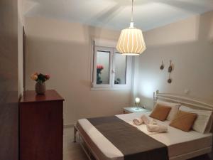 a bedroom with a bed with two towels on it at Peramos View Luxury Maisonette in Nea Peramos +1 photo