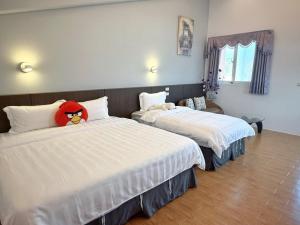 Ένα ή περισσότερα κρεβάτια σε δωμάτιο στο Wonderful Kenting Hostel