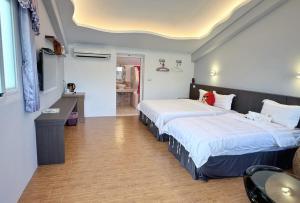 Ένα ή περισσότερα κρεβάτια σε δωμάτιο στο Wonderful Kenting Hostel