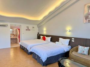 Ένα ή περισσότερα κρεβάτια σε δωμάτιο στο Wonderful Kenting Hostel