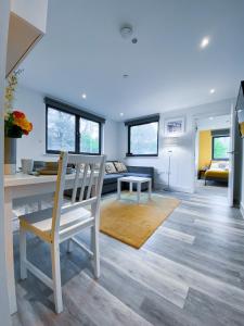 a living room with a table and a chair at Beachside Bliss in Bournemouth