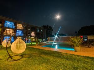 a building with a swimming pool at night at Sherbourne Hotel in Kitwe