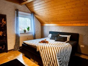 a bedroom with a bed with a wooden ceiling at Ferienhaus Goldgrube - 5 Zimmer - 140qm am Fluss in Katzweiler
