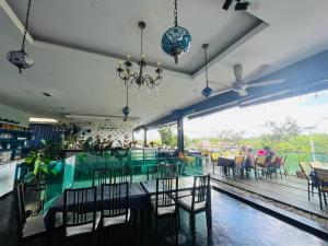 a dining room with a glass table and chairs at The Riverfront Hotel in Malacca