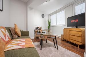 a living room with a couch and a tv at Cozy Waterfront Apartment - Free Parking & Wi-Fi in Preston