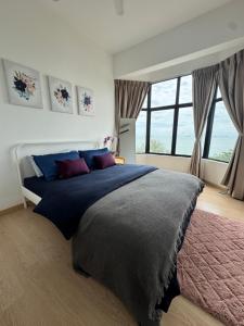 a bedroom with a large bed and a large window at SEAVIEW - BEACHFRONT - 2BR Apartment - Corner Unit- Mutiara Melaka Beach Resort Pantai Puteri in Melaka +51 photos