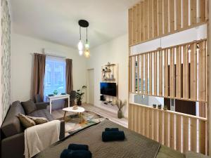 a living room with a couch and a tv at Colorful Condo by the Danube ---FREE PARKING--- in Budapest