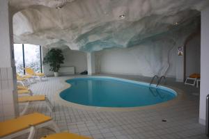 a swimming pool with a faux rock ceiling at Apartment 162 - Bristol in Villars-sur-Ollon