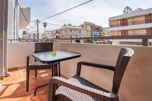 una pequeña mesa y sillas sentadas en un balcón en Silia apartments 2, en Ampavris