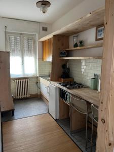a kitchen with white appliances and wooden cabinets at Casa Regis in San Giacomo