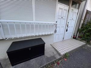 a black box sitting in front of a door at 千住4丁目2階 日本の和のお部屋スカイツリー9分秋葉原10分浅草12分 in Tokyo