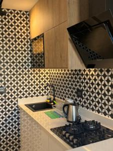 a kitchen with a sink and a stove top oven at Studio N in Beirut +5 photos