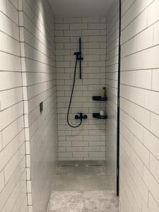 a bathroom with a shower with white tiles at Studio N in Beirut