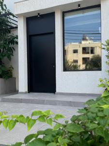 a black door on the side of a house at Studio N in Beirut