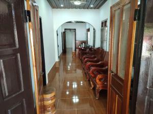 a corridor with a row of chairs in a room at Chalern Guesthouse in Luang Prabang