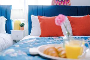 a tray with a plate of donuts on a bed at Jephsons Lodge Studio 3 - Free Netflix, Parking, WiFi in Leamington Spa