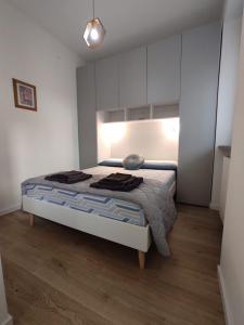 a bedroom with a bed in a white room at La Langhetta in Alba