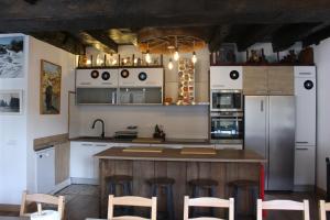 a kitchen with a large island with bar stools at Casa Xauri in Aria