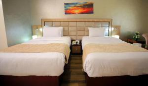 Voodi või voodid majutusasutuse Cairo Taj Hotels & Suites - Dokki toas